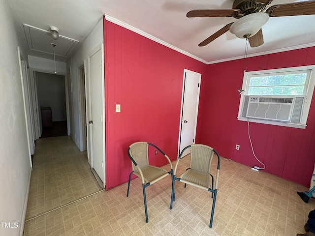 sitting room featuring cooling unit, ornamental molding, and ceiling fan