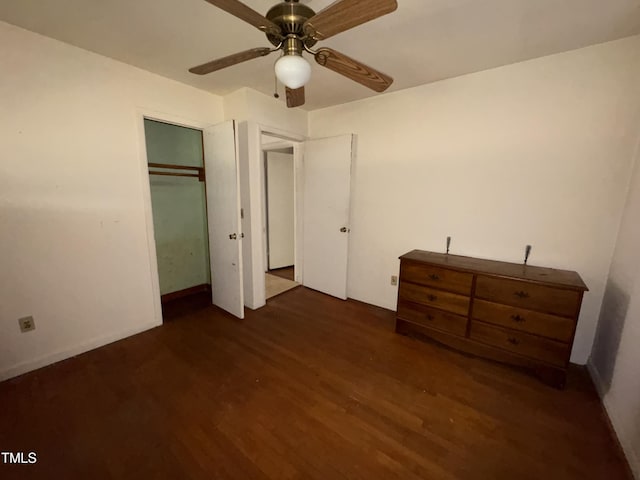 unfurnished bedroom with dark wood-type flooring and ceiling fan