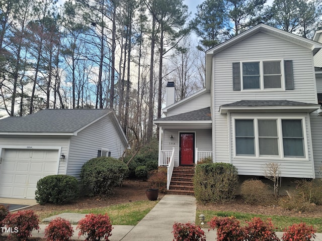 traditional-style house with covered porch, a chimney, and a shingled roof