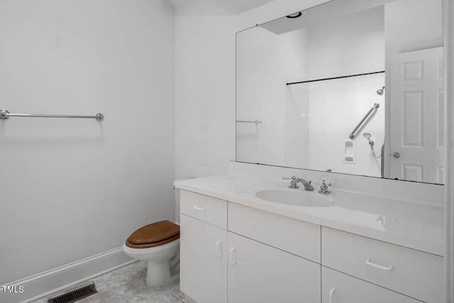 bathroom with tile patterned flooring, visible vents, baseboards, toilet, and vanity