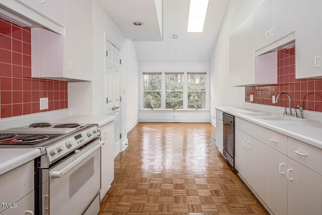 kitchen featuring a sink, tasteful backsplash, black dishwasher, electric range oven, and light countertops