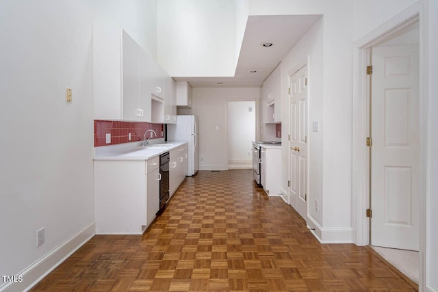 kitchen with backsplash, stainless steel electric range oven, light countertops, black dishwasher, and white cabinetry