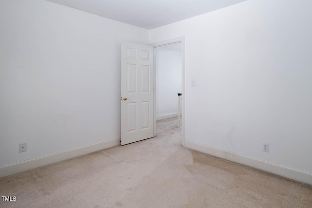 empty room with baseboards and carpet floors