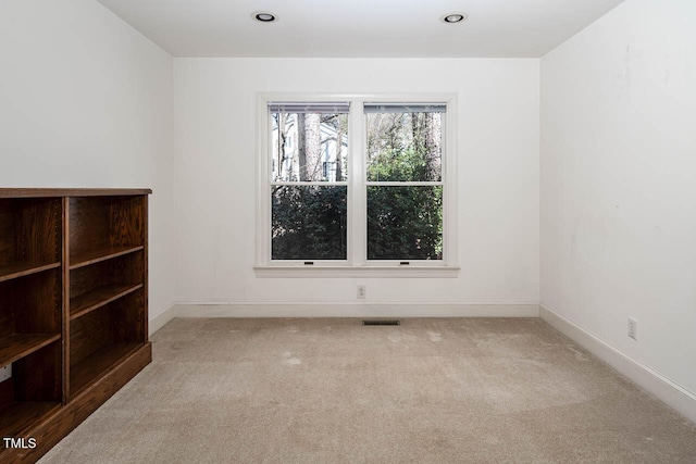 spare room with recessed lighting, baseboards, visible vents, and light carpet