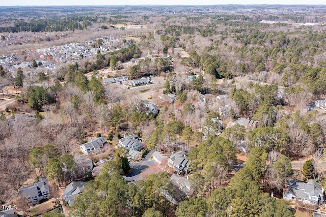 drone / aerial view featuring a wooded view