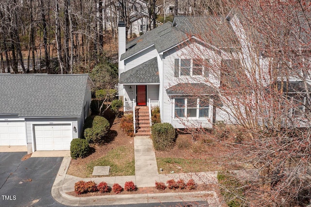 view of front of house with a shingled roof and a chimney