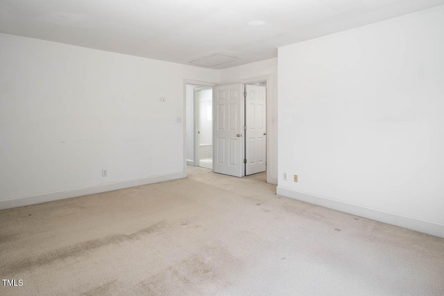 carpeted empty room with baseboards