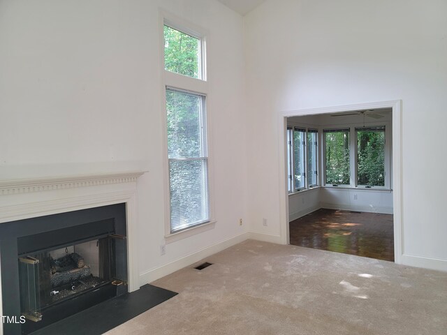 595 Weathersfield Unit A, Pittsboro, NC 27312 - unfurnished living room featuring visible vents, plenty of natural light, baseboards, and carpet floors