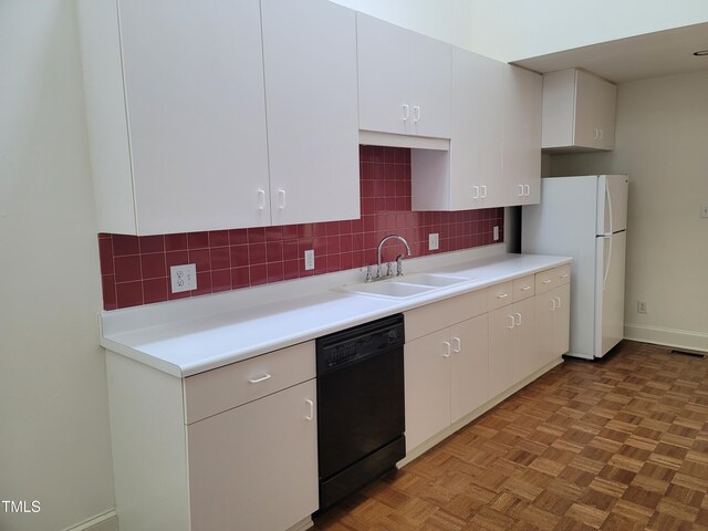 kitchen with dishwasher, backsplash, a sink, and visible vents