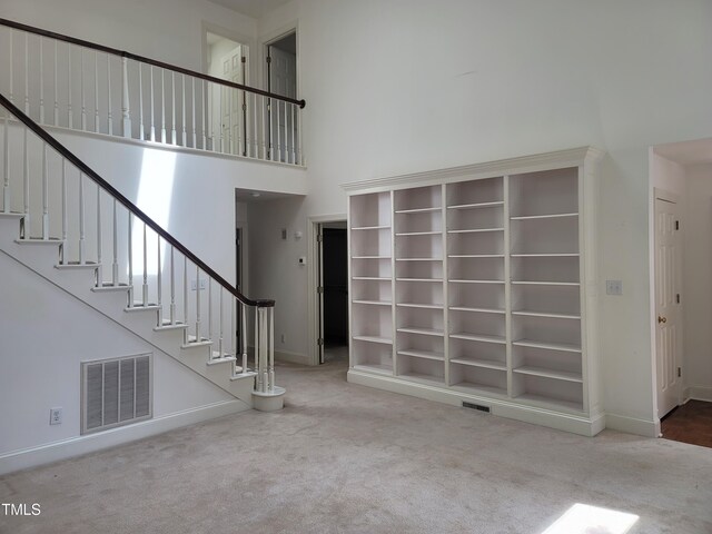 595 Weathersfield Unit A, Pittsboro, NC 27312 - stairs featuring a towering ceiling, baseboards, visible vents, and carpet