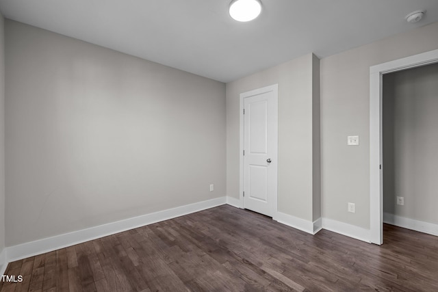 unfurnished bedroom with dark wood-type flooring