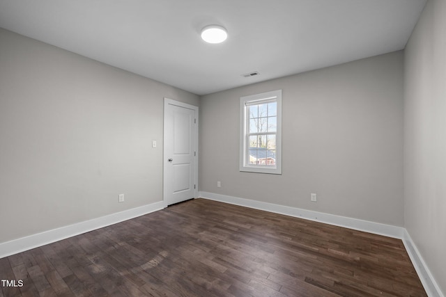 unfurnished room featuring dark hardwood / wood-style floors