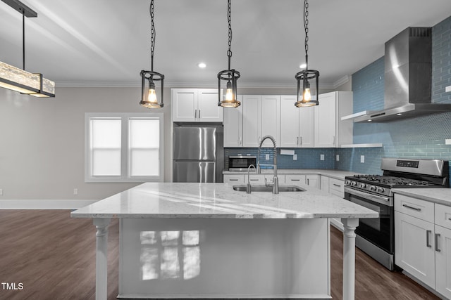 kitchen with wall chimney range hood, a kitchen breakfast bar, sink, and appliances with stainless steel finishes