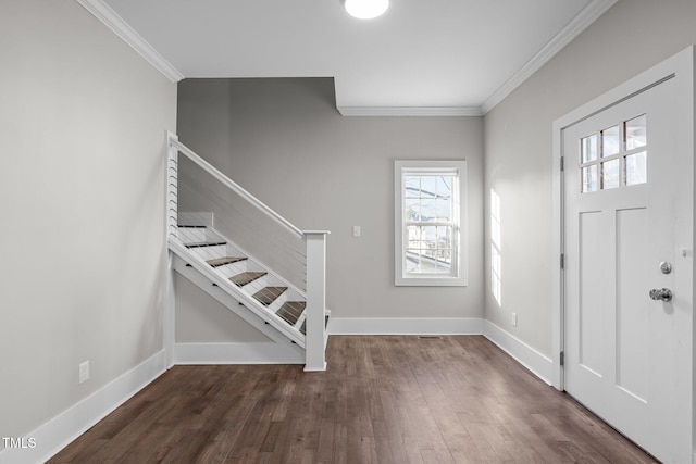 entrance foyer with dark hardwood / wood-style flooring and crown molding