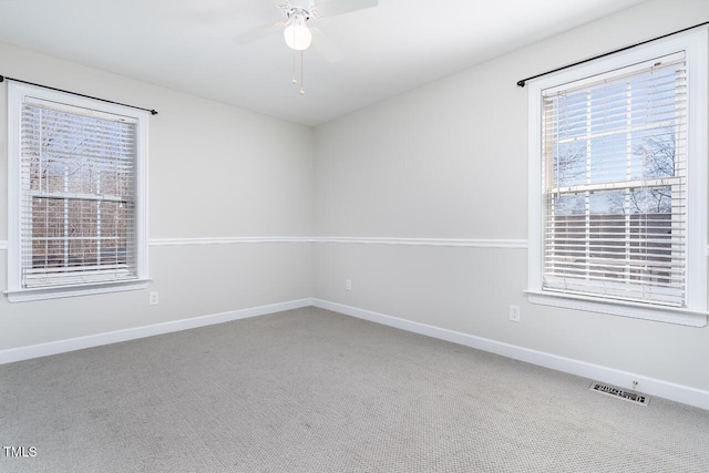 carpeted spare room with ceiling fan