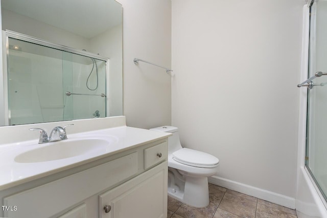 full bathroom featuring vanity, bath / shower combo with glass door, tile patterned floors, and toilet