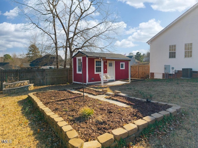 view of outbuilding with a yard and central air condition unit