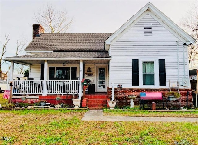 bungalow-style house featuring a porch and a front lawn