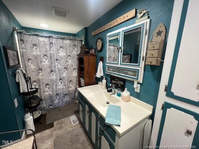 bathroom with vanity and a shower with shower curtain