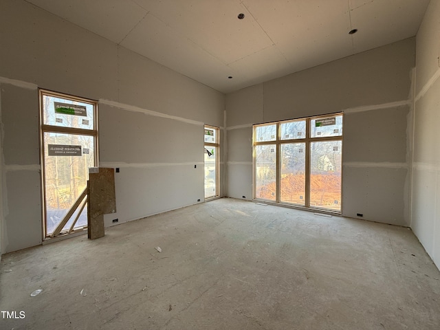 unfurnished room with a high ceiling