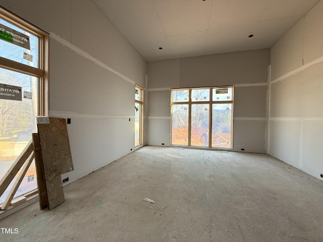 unfurnished room featuring a high ceiling