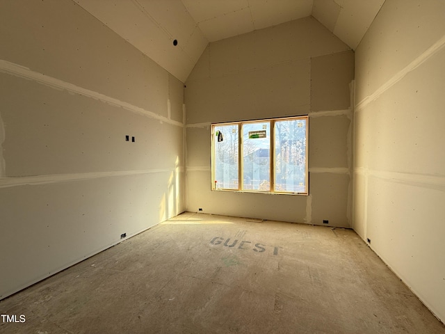 unfurnished room with high vaulted ceiling