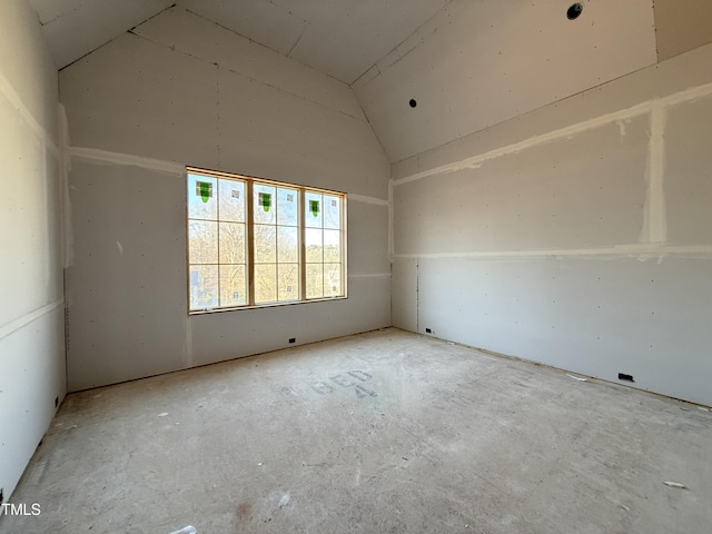 spare room with vaulted ceiling