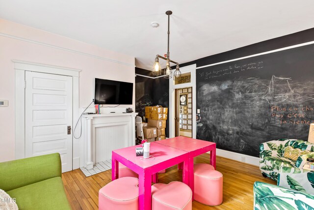 game room featuring a chandelier and light hardwood / wood-style flooring