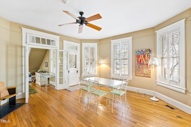 dining room with ceiling fan, light hardwood / wood-style floors, and french doors