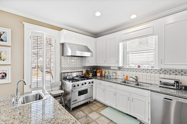 kitchen with white cabinetry, wall chimney exhaust hood, stainless steel appliances, and sink