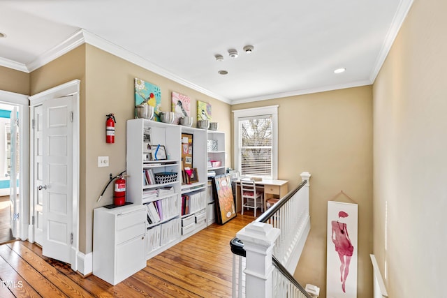 kitchen with wood-type flooring and crown molding