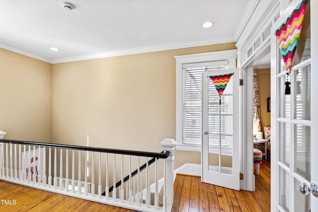 interior space featuring wood-type flooring, ornamental molding, and french doors