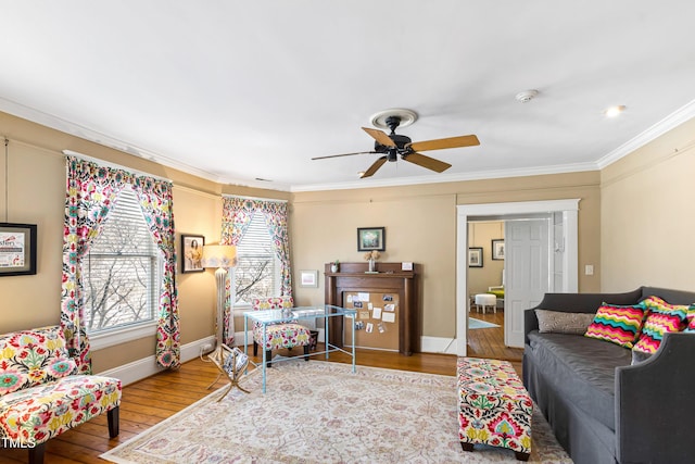 living room with crown molding, wood-type flooring, and ceiling fan