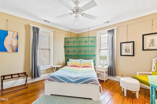 bedroom with crown molding, ceiling fan, and wood-type flooring