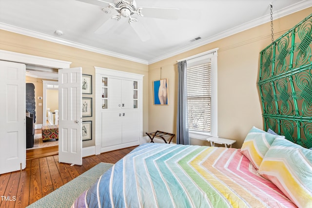 bedroom with wood-type flooring, ornamental molding, and ceiling fan