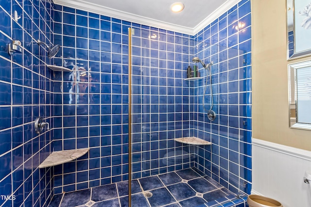 bathroom with crown molding and a tile shower