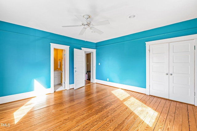 unfurnished bedroom featuring wood-type flooring, a closet, and ceiling fan