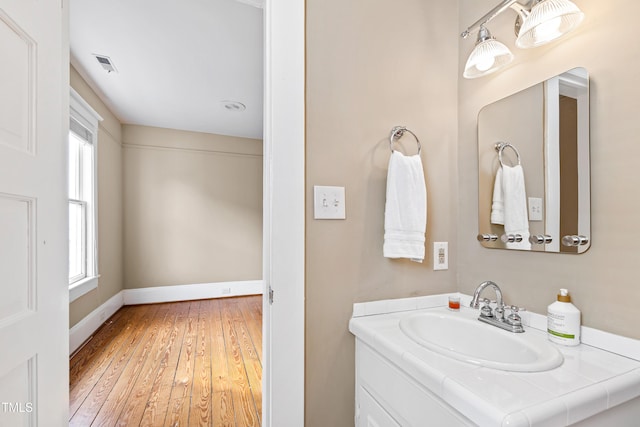 bathroom with hardwood / wood-style flooring and vanity