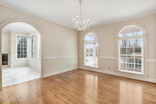 interior space with crown molding, a chandelier, and light hardwood / wood-style floors