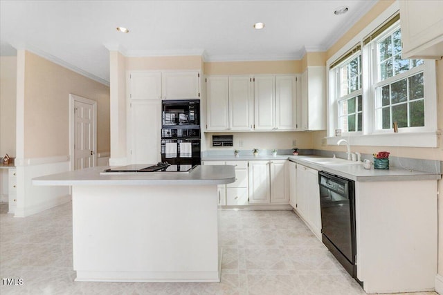 kitchen with sink, crown molding, white cabinetry, black appliances, and a kitchen island