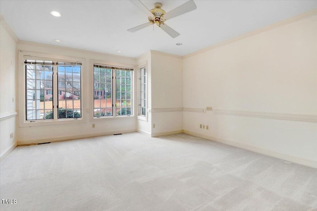 unfurnished room featuring ornamental molding, light carpet, and ceiling fan