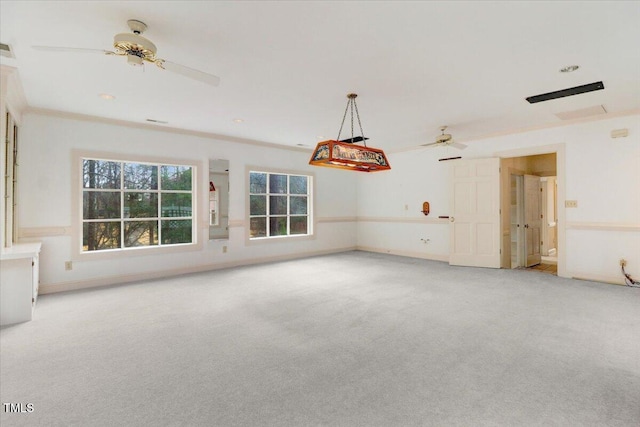 unfurnished living room featuring ornamental molding, light carpet, and ceiling fan