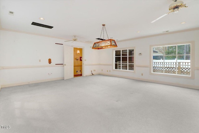 empty room with crown molding, carpet floors, and ceiling fan