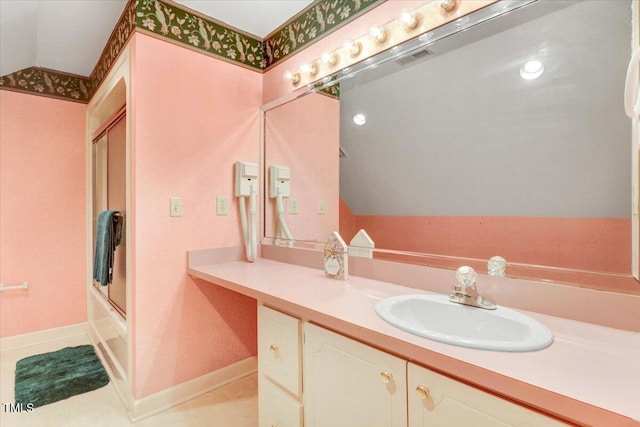 bathroom featuring vanity, vaulted ceiling, tile patterned floors, and combined bath / shower with glass door