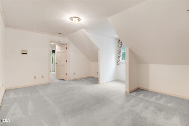 additional living space with light carpet and lofted ceiling