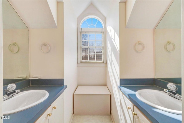 bathroom with lofted ceiling and vanity