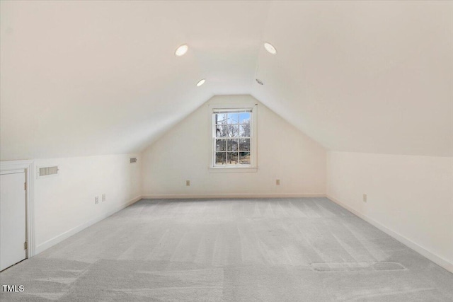 bonus room featuring light colored carpet and lofted ceiling