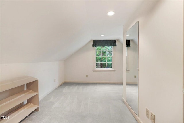 bonus room featuring lofted ceiling and light colored carpet