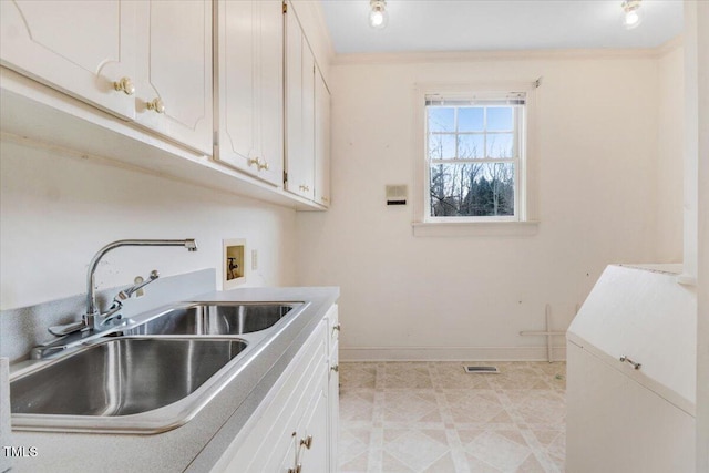 laundry room with cabinets, ornamental molding, hookup for a washing machine, and sink