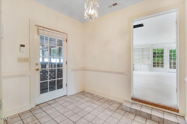 doorway to outside featuring crown molding, built in shelves, a chandelier, and light tile patterned flooring